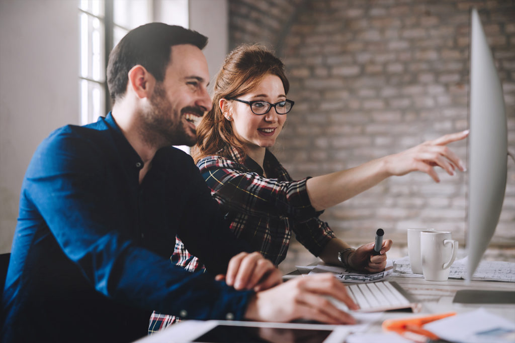 Employees at the Yango Sydney office working with a client on a outsourced programmatic media buying and trading solution.